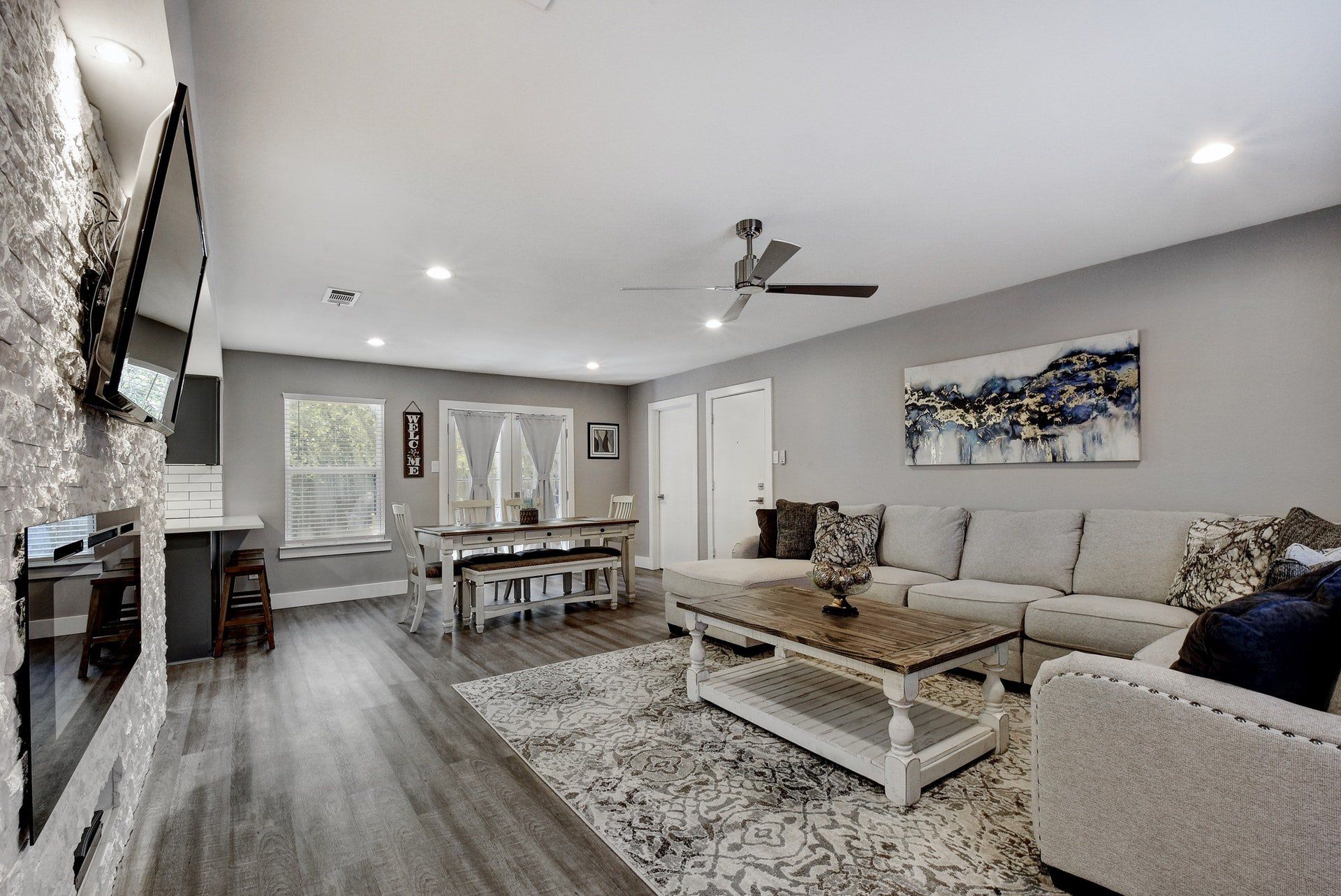 A living room with a couch , coffee table , fireplace and television.