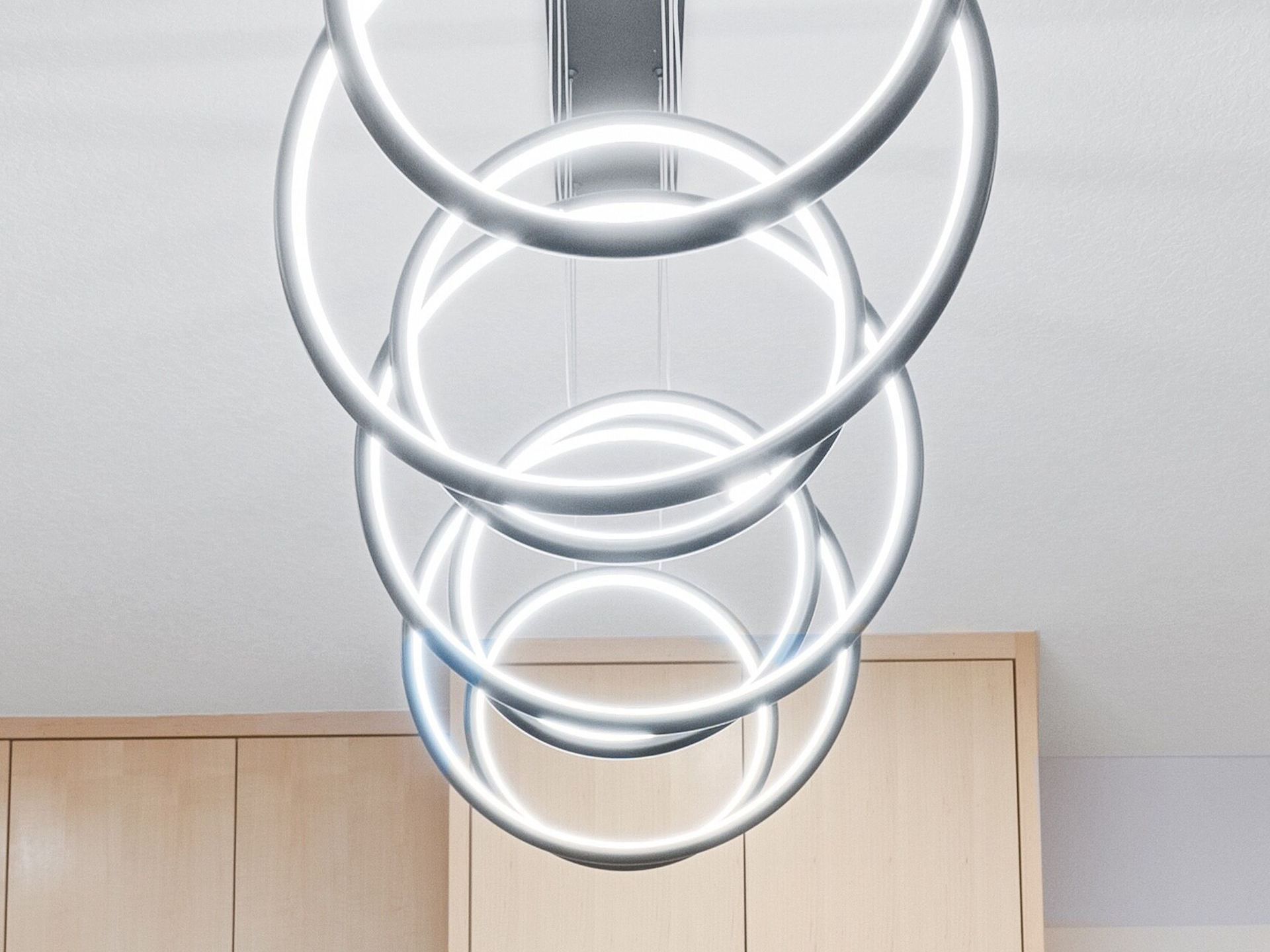 A bunch of circles are hanging from the ceiling