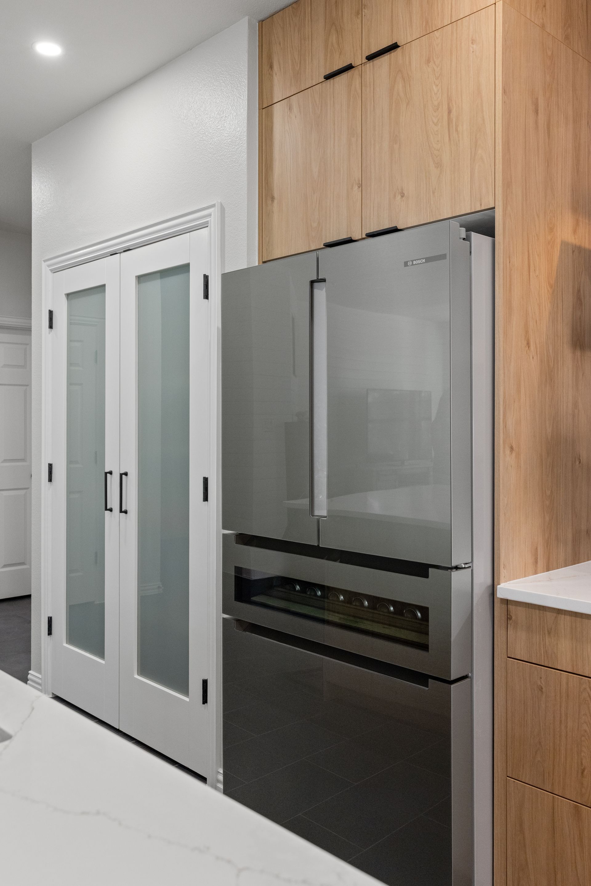 counter depth refrigerator and pantry doors with frosted glass