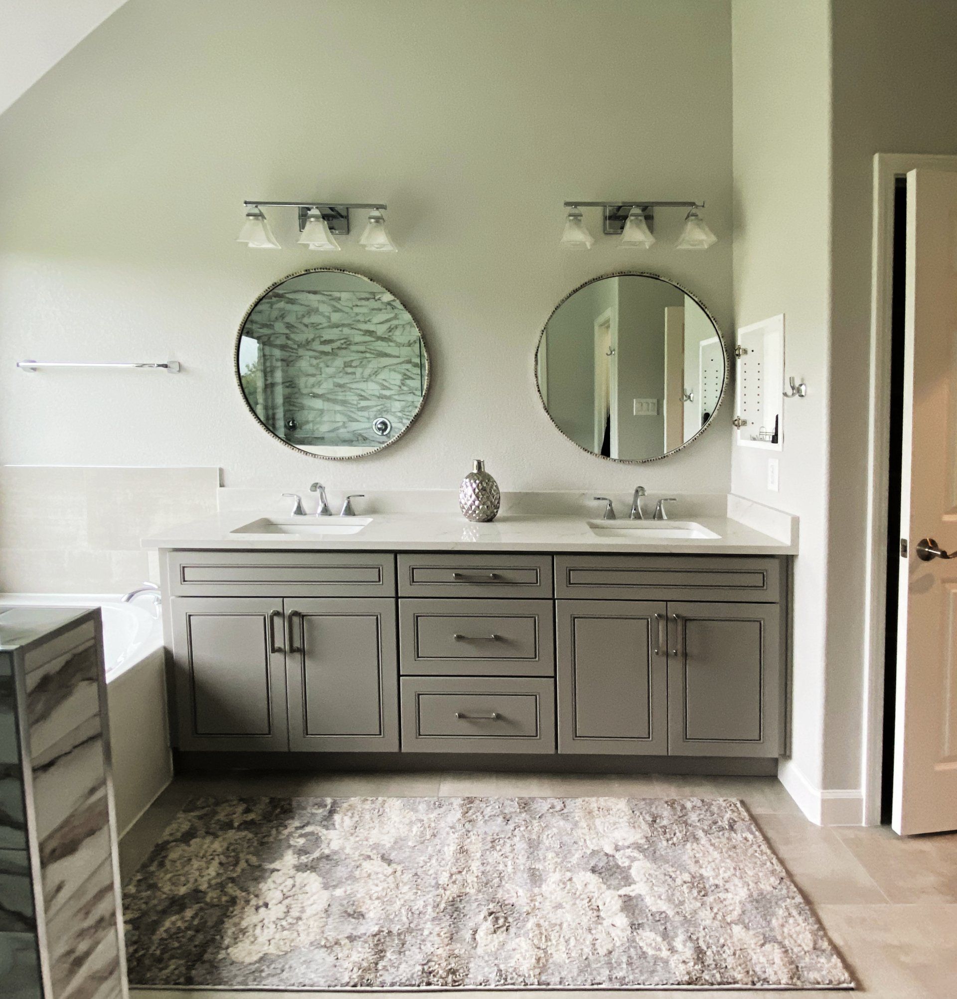 A bathroom with two sinks and two mirrors