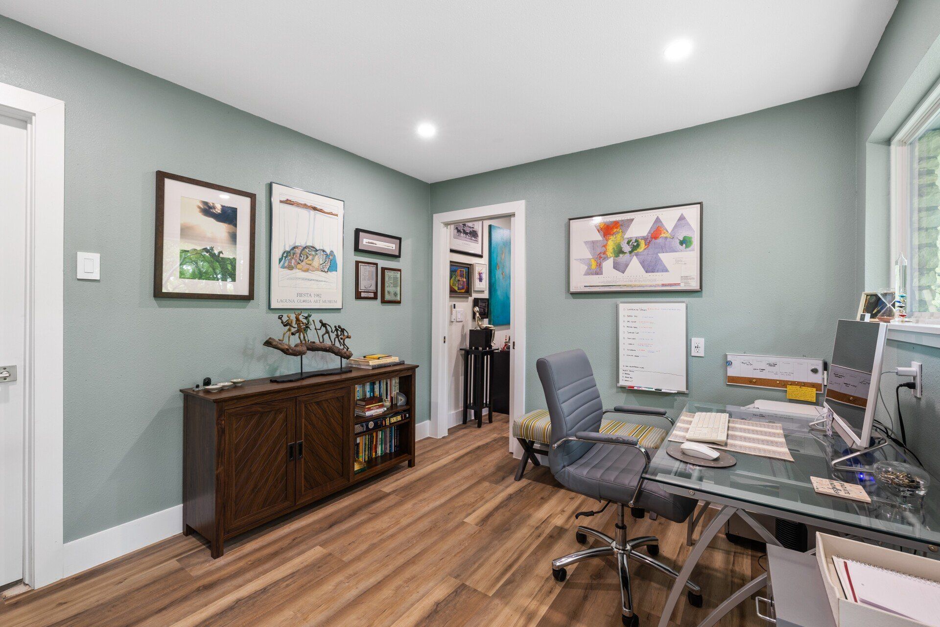 A home office with a desk , chair , and computer.