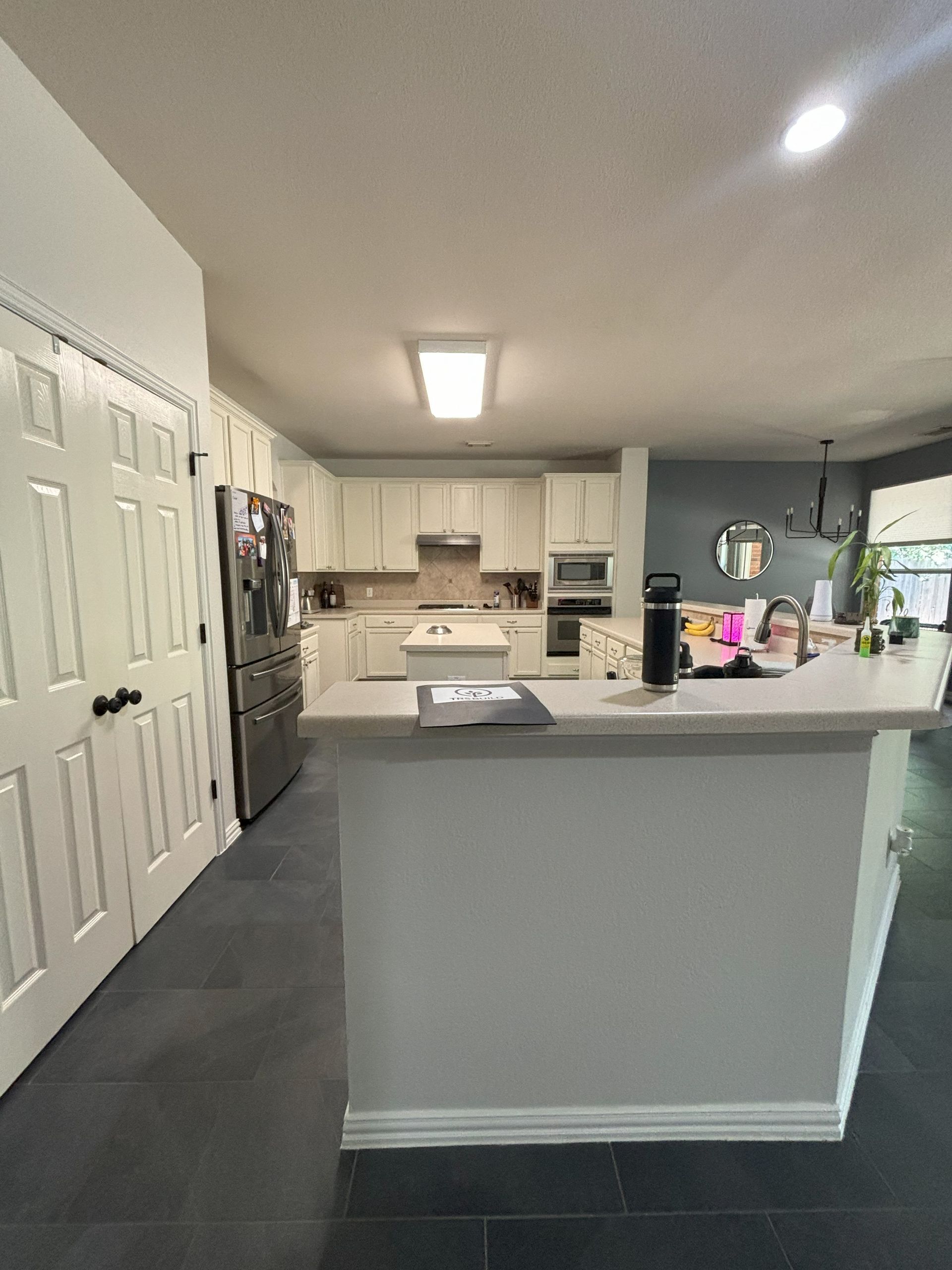 Island with bartop in white kitchen