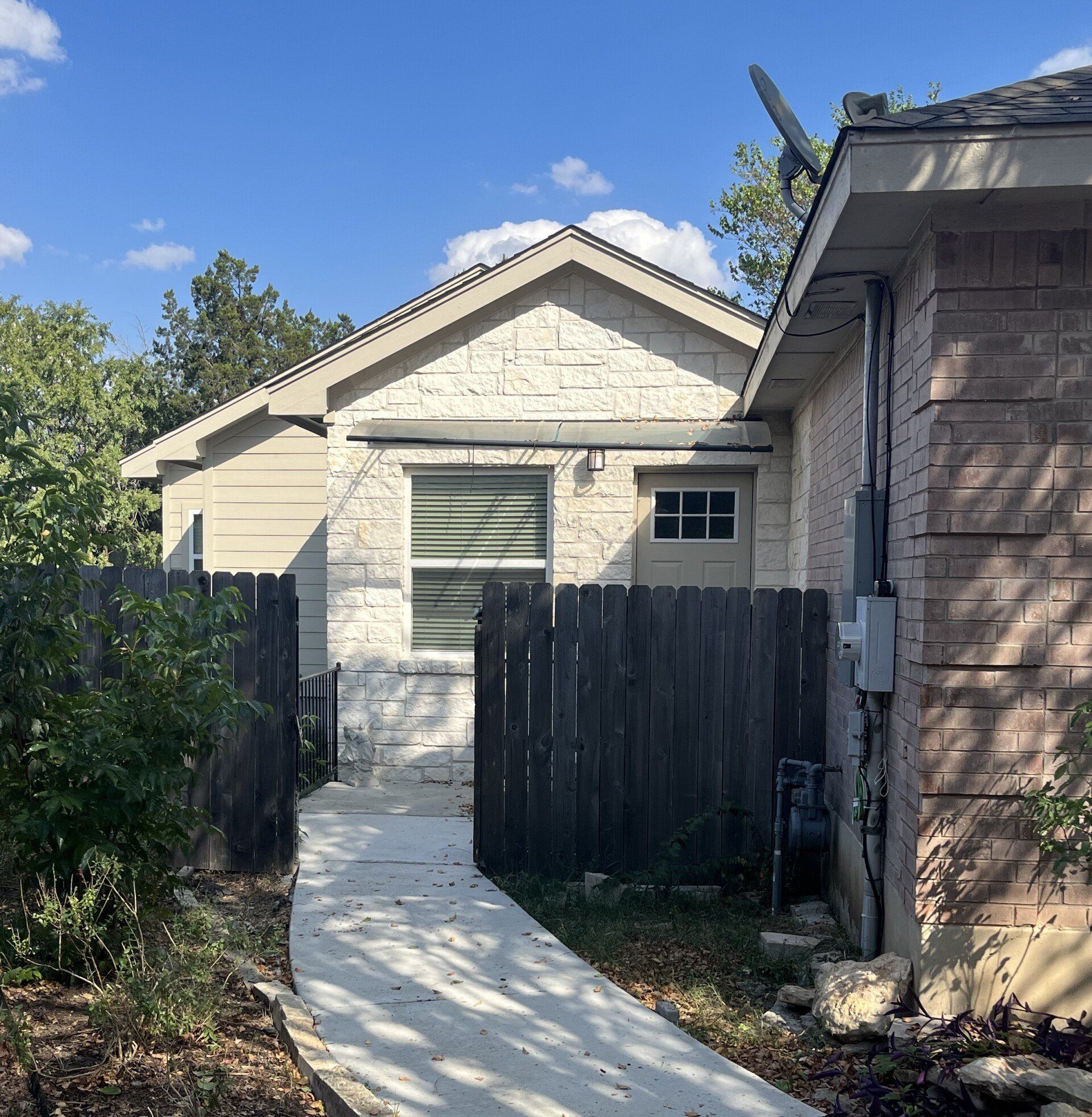 A brick house with a wooden fence surrounding it