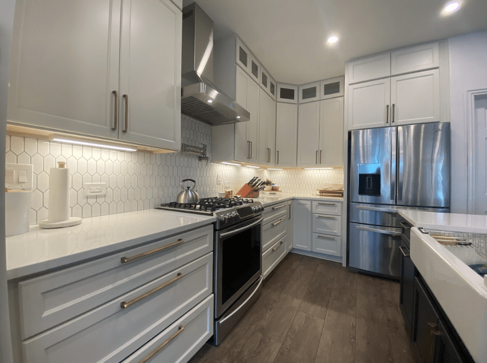A kitchen with white cabinets and stainless steel appliances.