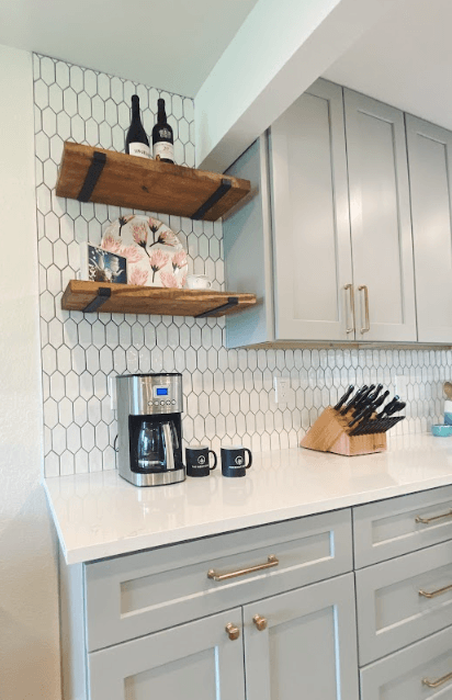 A kitchen with white cabinets and a coffee maker on the counter.