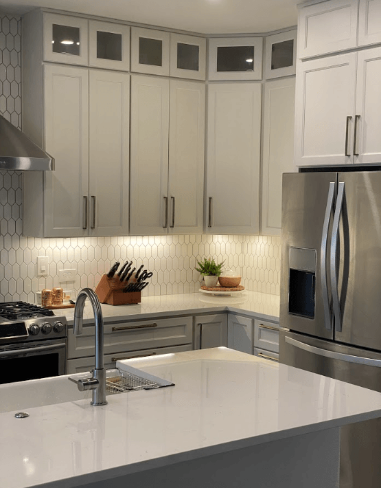 A kitchen with stainless steel appliances and white cabinets