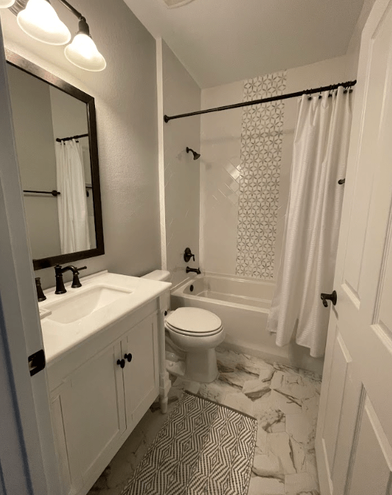 A bathroom with a toilet a sink and a bathtub