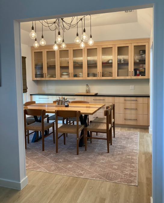A kitchen with a table and chairs in it