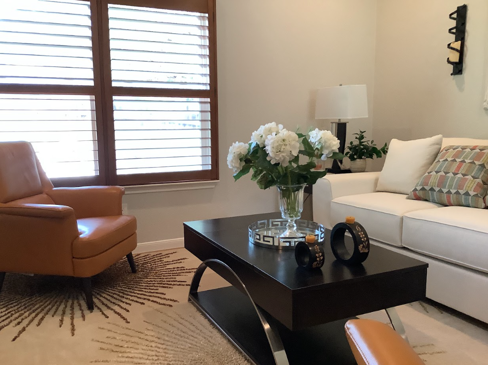 A living room with a couch a chair and a coffee table