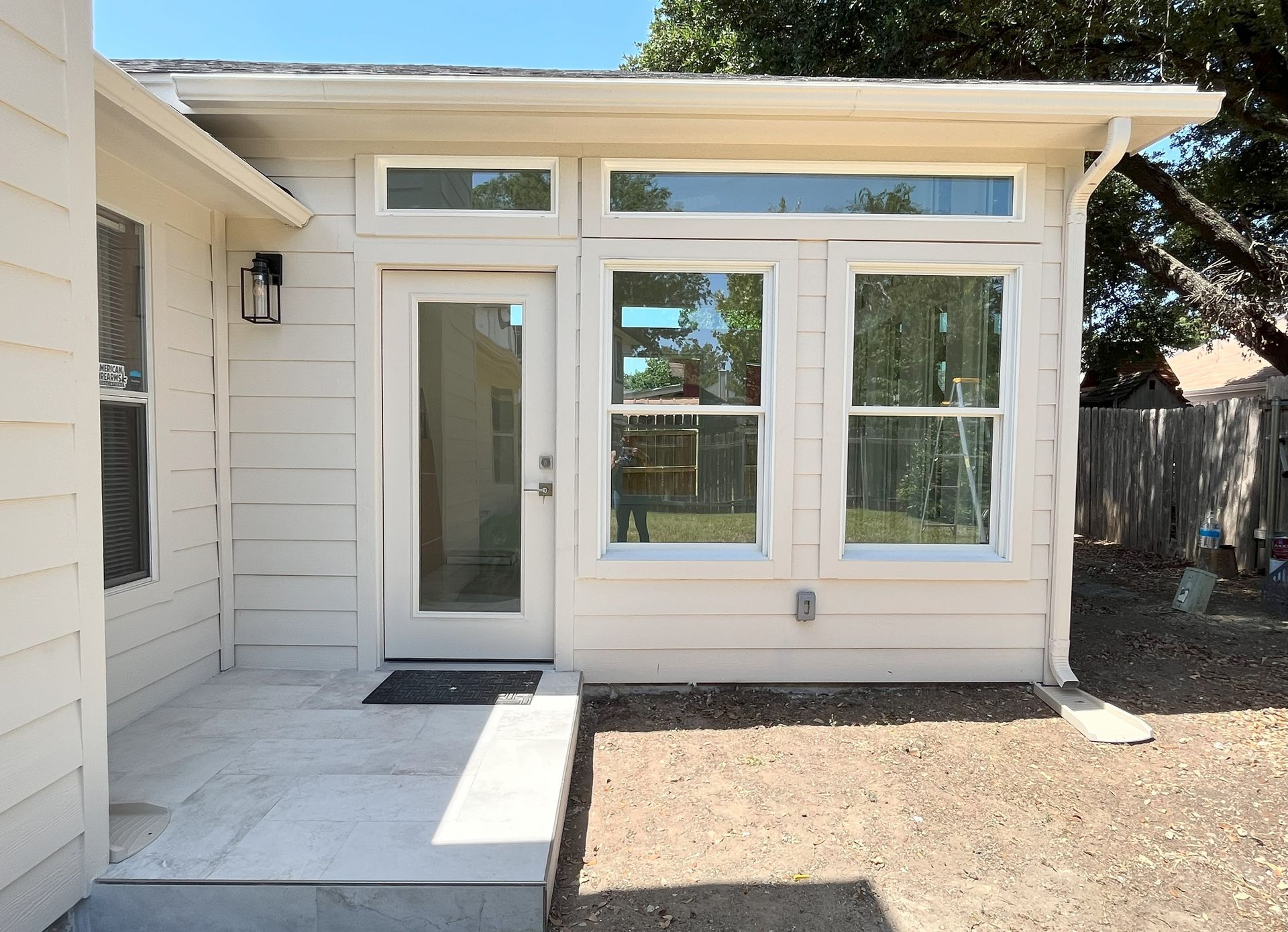 A small white house with a sliding glass door