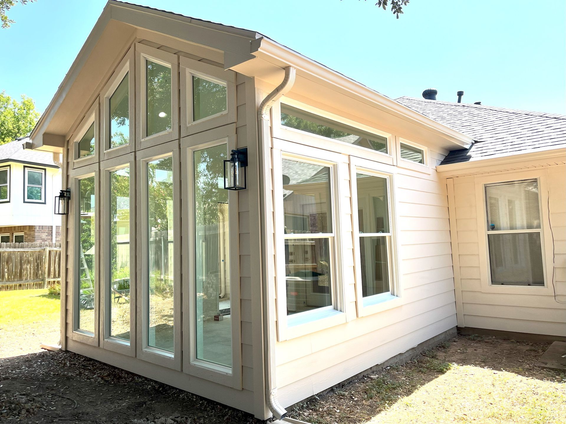 A house with a lot of windows on the side of it.