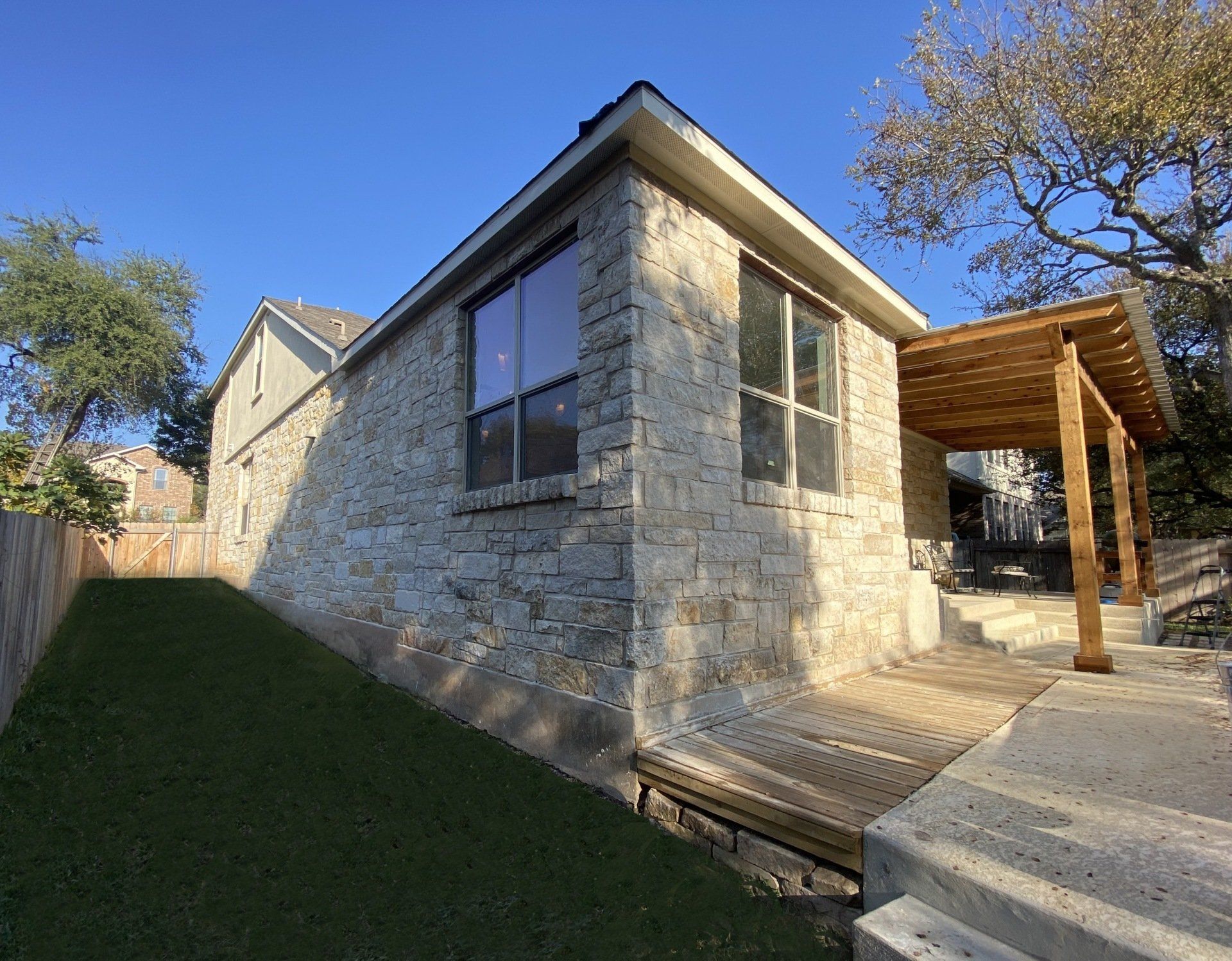 A kitchen with white cabinets and wooden floors and a large island.
