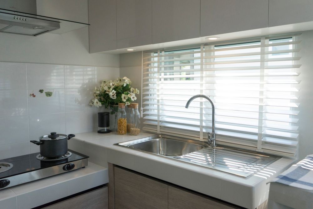 Modern Kitchen With Sink, Stove, And Window With Blinds — Red Door Decor In Dubbo, NSW