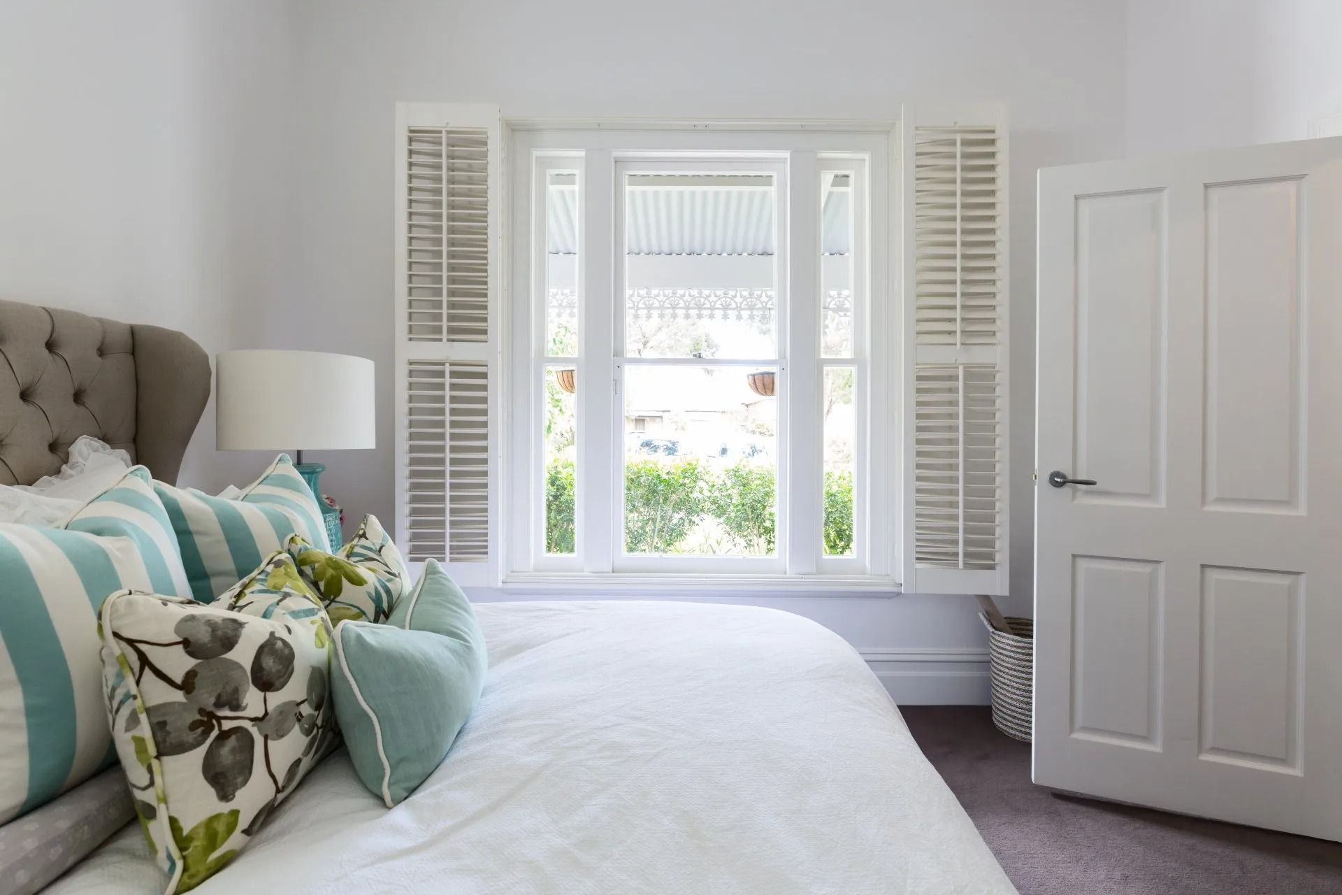 Bedroom With White Bedding, Pillows, and Shutters. Open Door to the Right — Red Door Decor In Dubbo, NSW