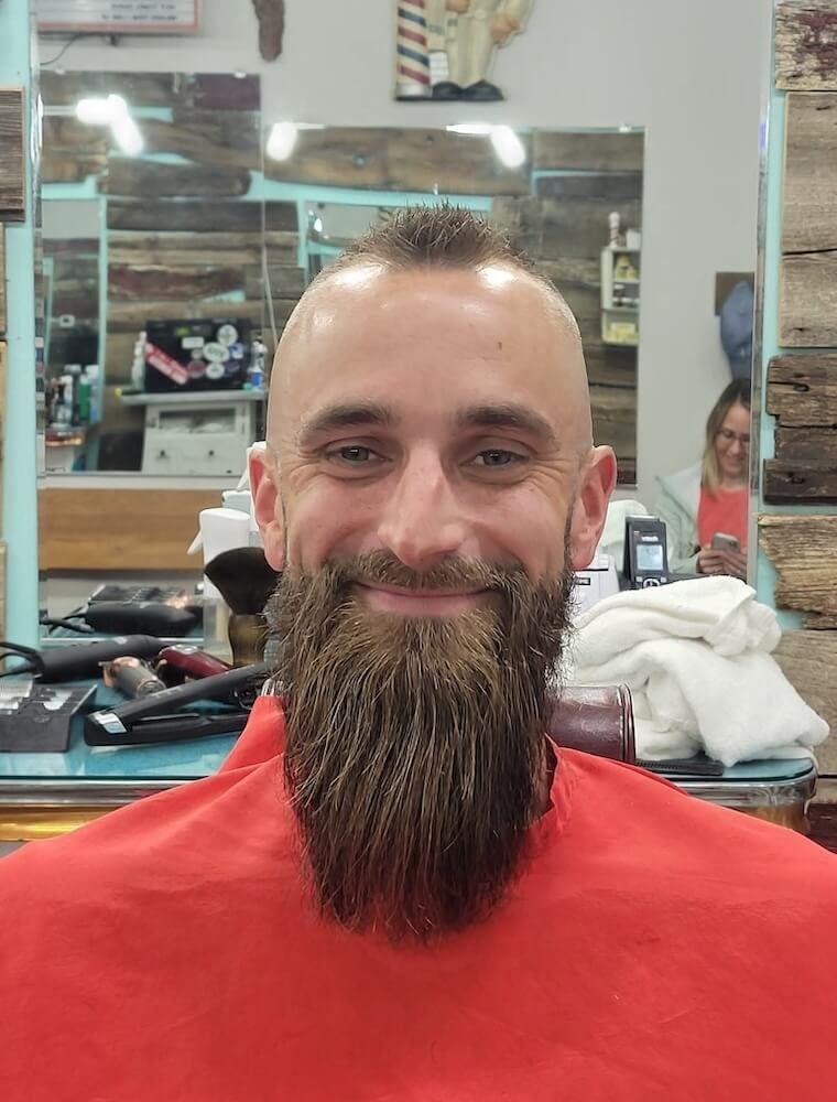 smiling client with finished haircut