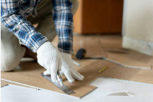 Young man placing a laminate floor. Young man placing a laminate floor.
