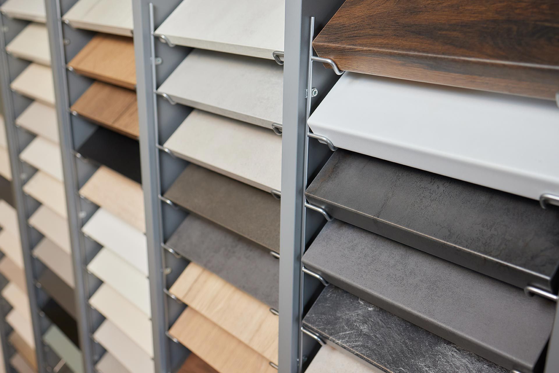 Diverse hardwood samples inside a tile flooring store showroom display. Diverse hardwood samples inside a tile flooring store showroom display.