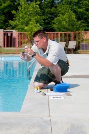 man cleaning swimming pool - swimming pool cleaning in  Tallahassee, FL