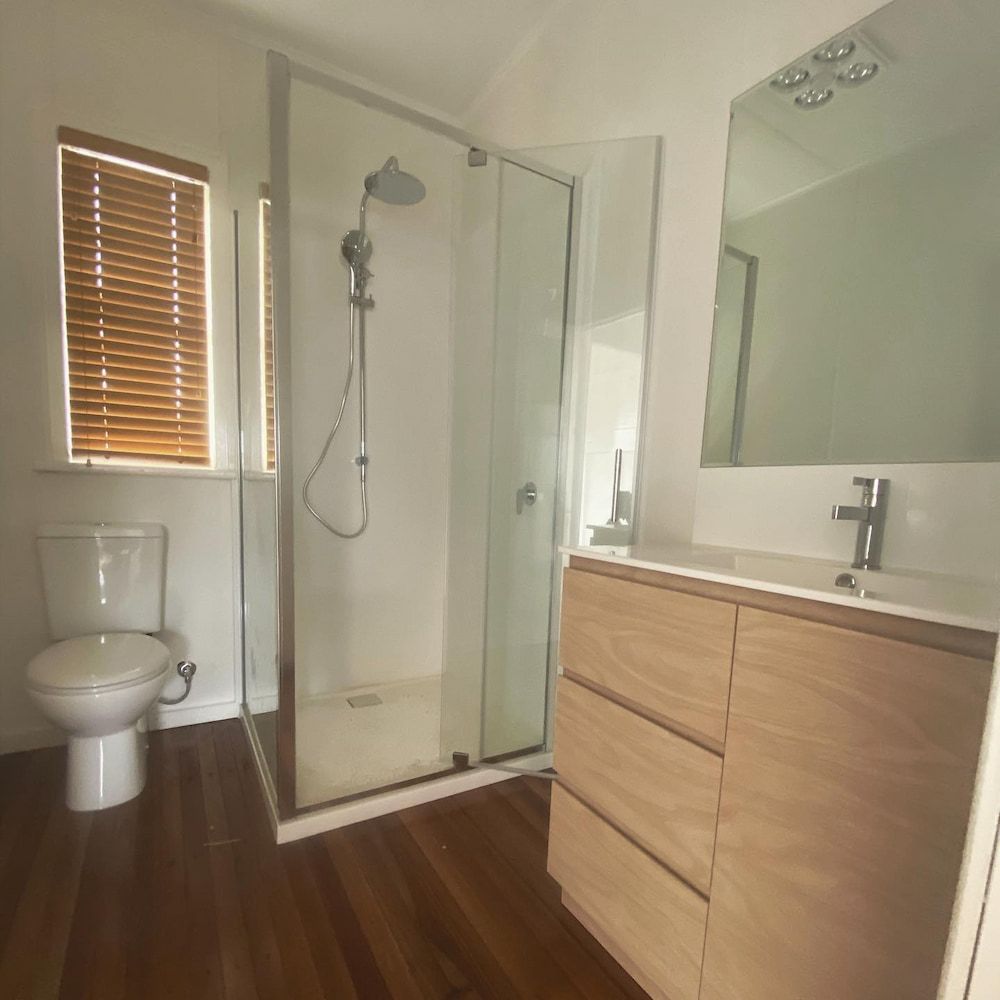 A Bathroom With a Toilet a Sink and a Shower — CJM Plumbing & Roofing Mackay in Mackay, QLD