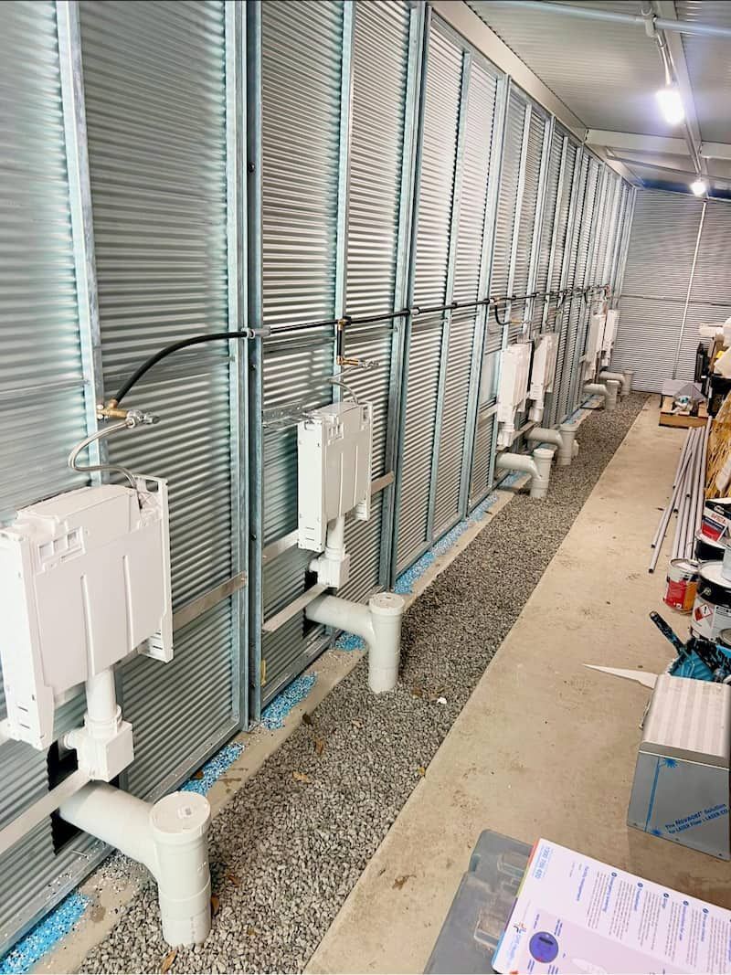 A Row of Toilets Are Being Installed in a Building Under Construction — CJM Plumbing & Roofing Mackay in Mackay, QLD