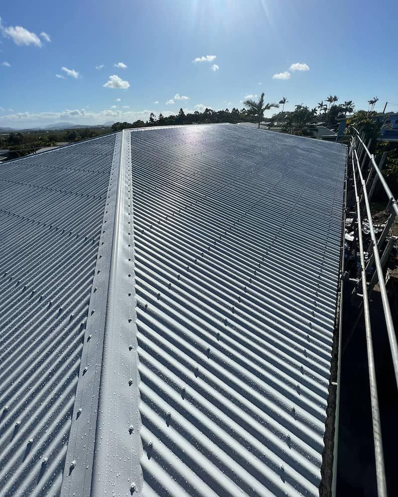 A Close Up of a Roof With a Blue Sky in the Background — CJM Plumbing & Roofing Mackay in Mackay, QLD