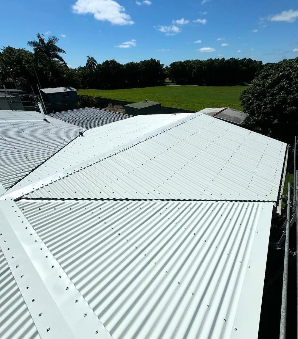 A Close Up of a Corrugated Metal Roof on a House — CJM Plumbing & Roofing Mackay in Marian, QLD
