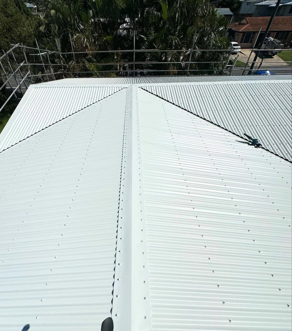 A Close Up of a White Roof With Trees in the Background — CJM Plumbing & Roofing Mackay in Mackay, QLD