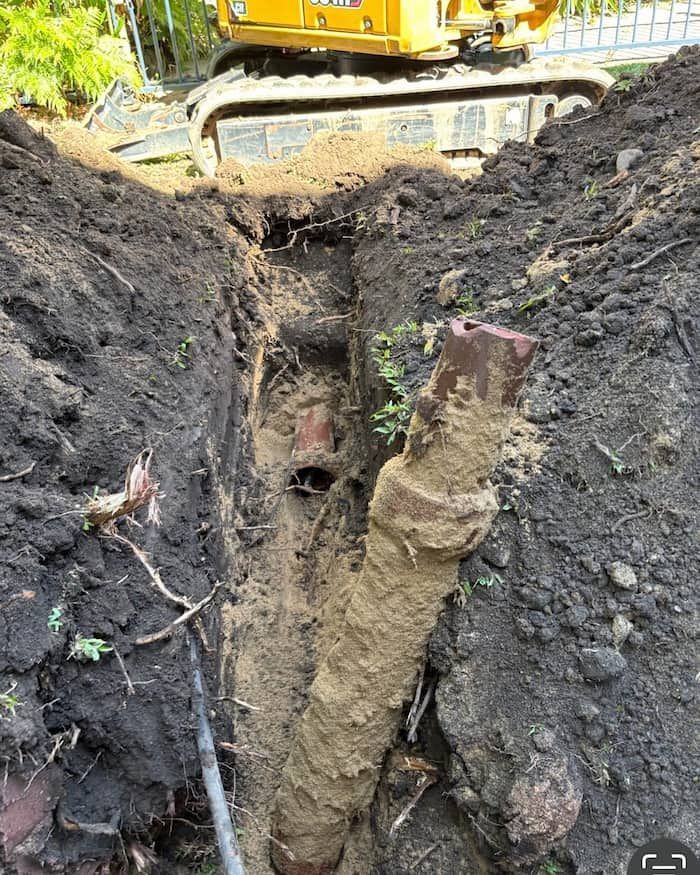 A Close Up of a Dirty Pipe With Roots Coming Out of It — CJM Plumbing & Roofing Mackay in Mackay, QLD