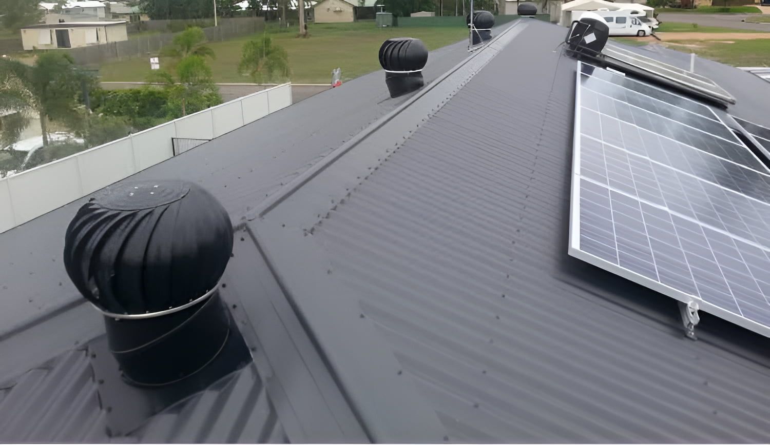 A Black Roof With a Solar Panel on It — CJM Plumbing & Roofing Mackay in Mackay, QLD