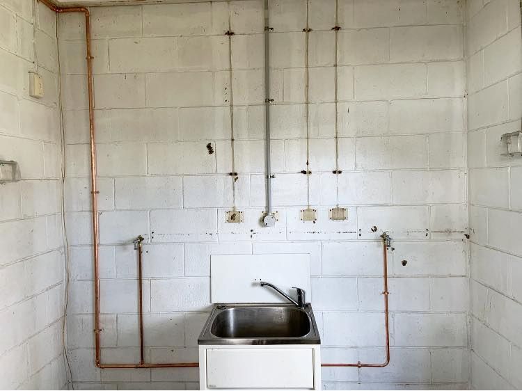 A Bathroom With a Sink and Copper Pipes — CJM Plumbing & Roofing Mackay in Sarina, QLD