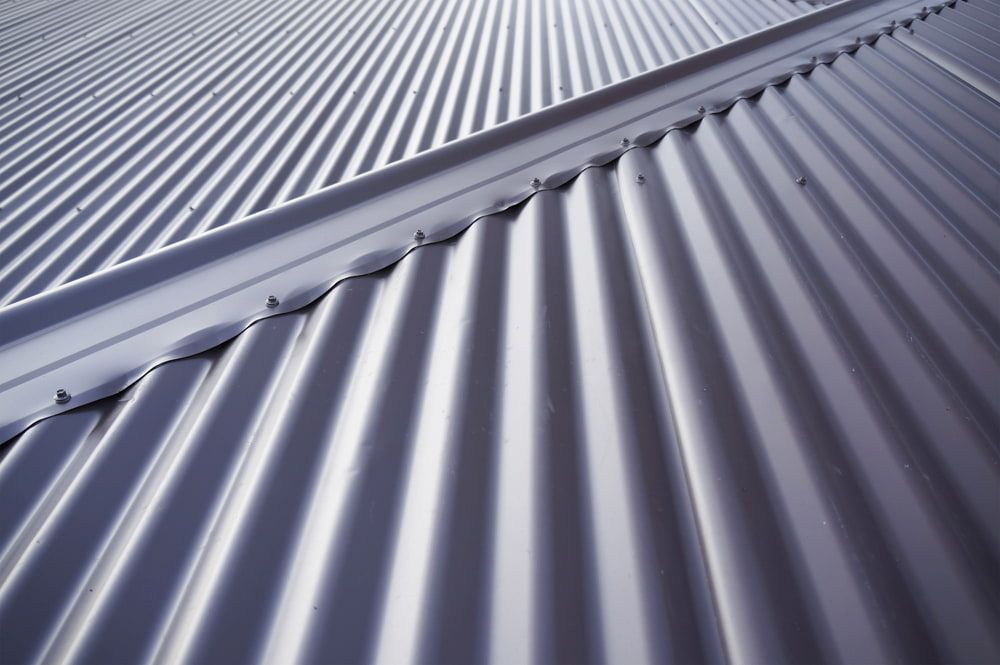 A Close Up of a Metal Roof With a Diagonal Pattern — CJM Plumbing & Roofing Mackay in Sarina, QLD