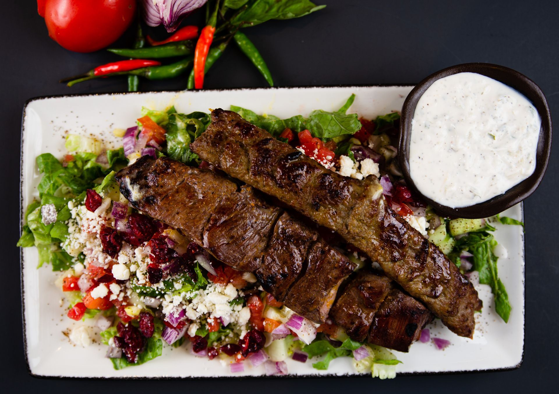 A plate of food with meat and vegetables on a table.