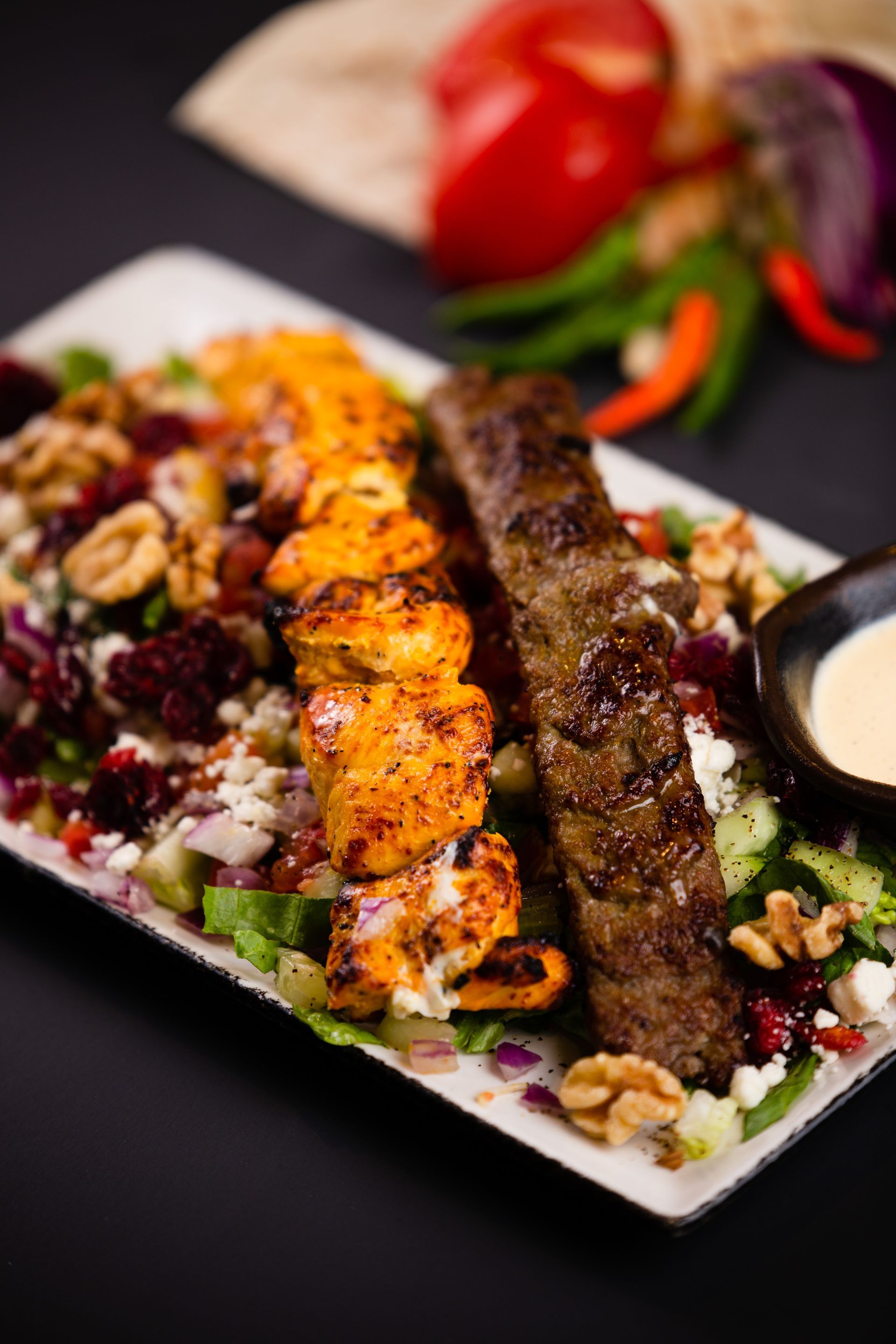 A plate of food with meat and vegetables on a table.