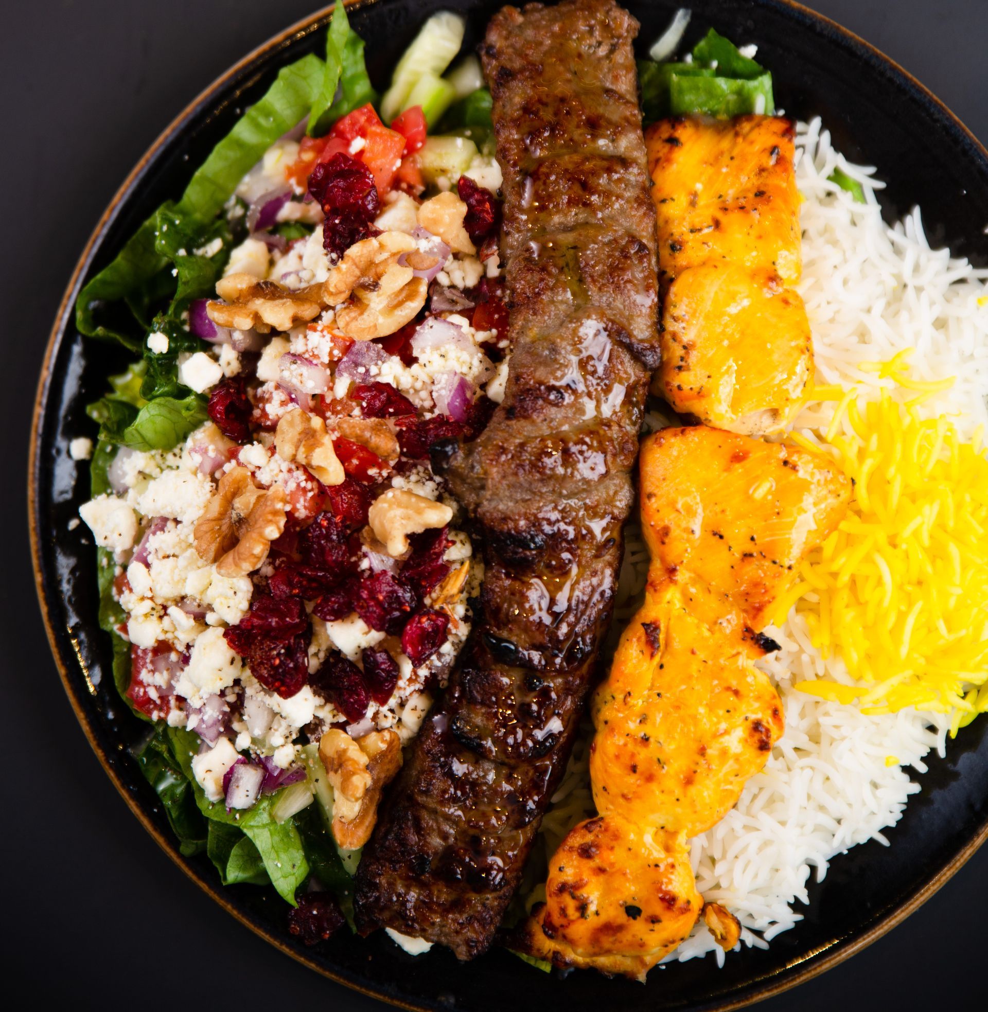 A close up of a plate of food with meat and rice