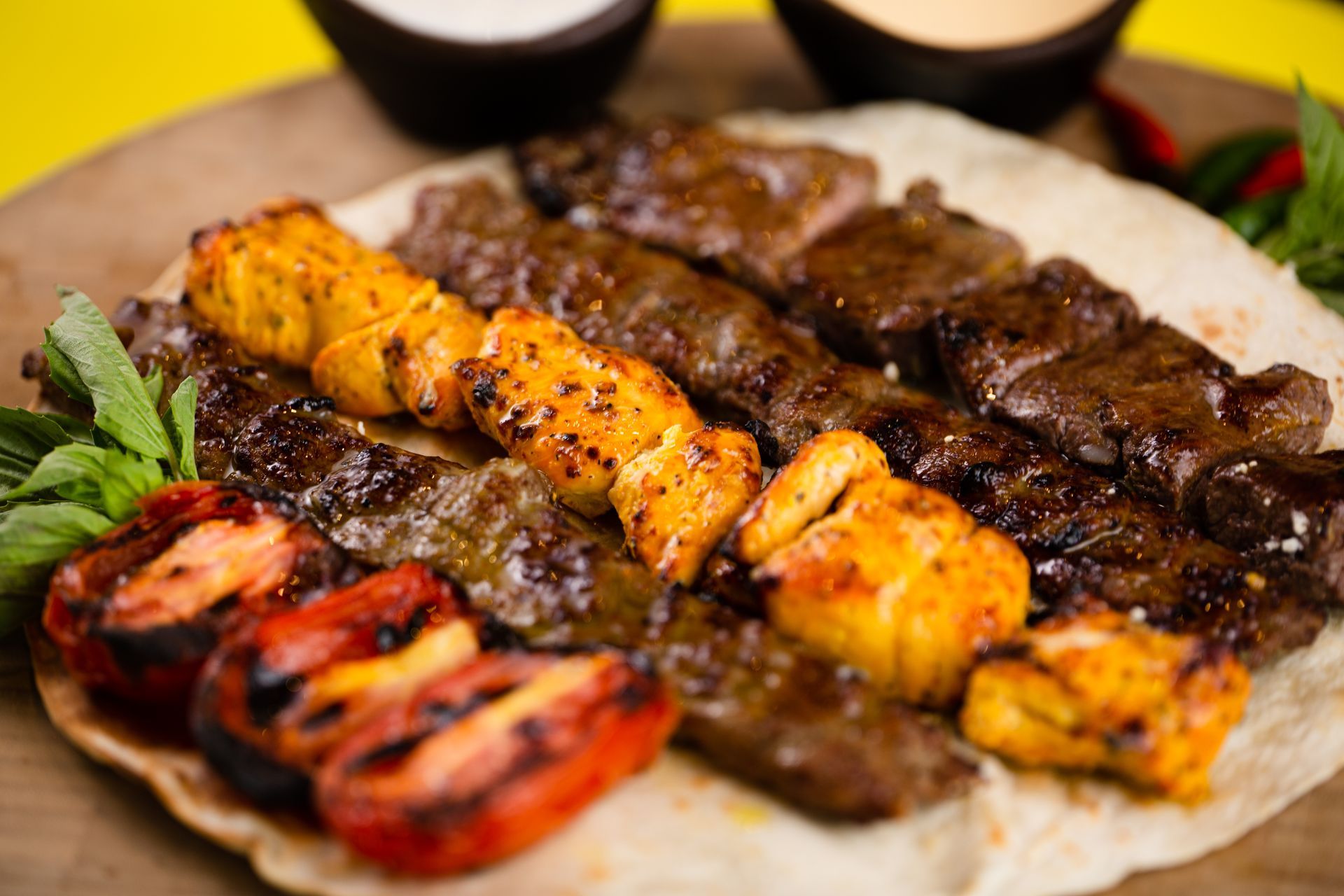 A close up of a plate of food on a wooden table.