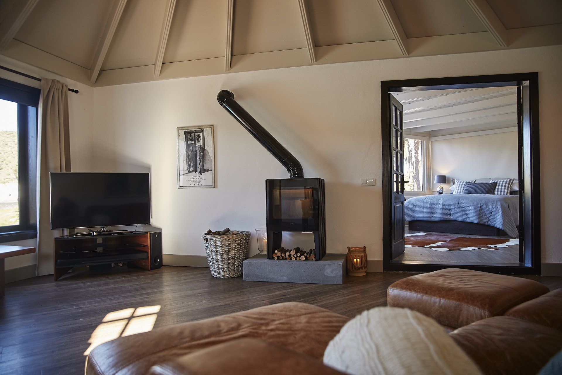 A living room with a fireplace and a flat screen tv.