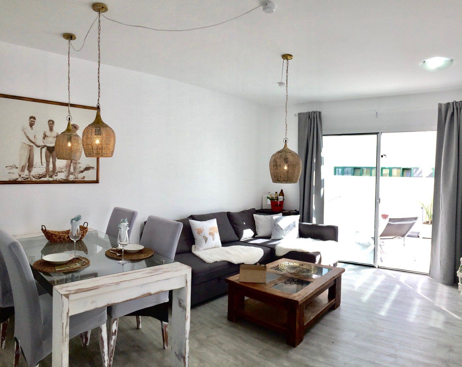 A living room with a couch , table and chairs