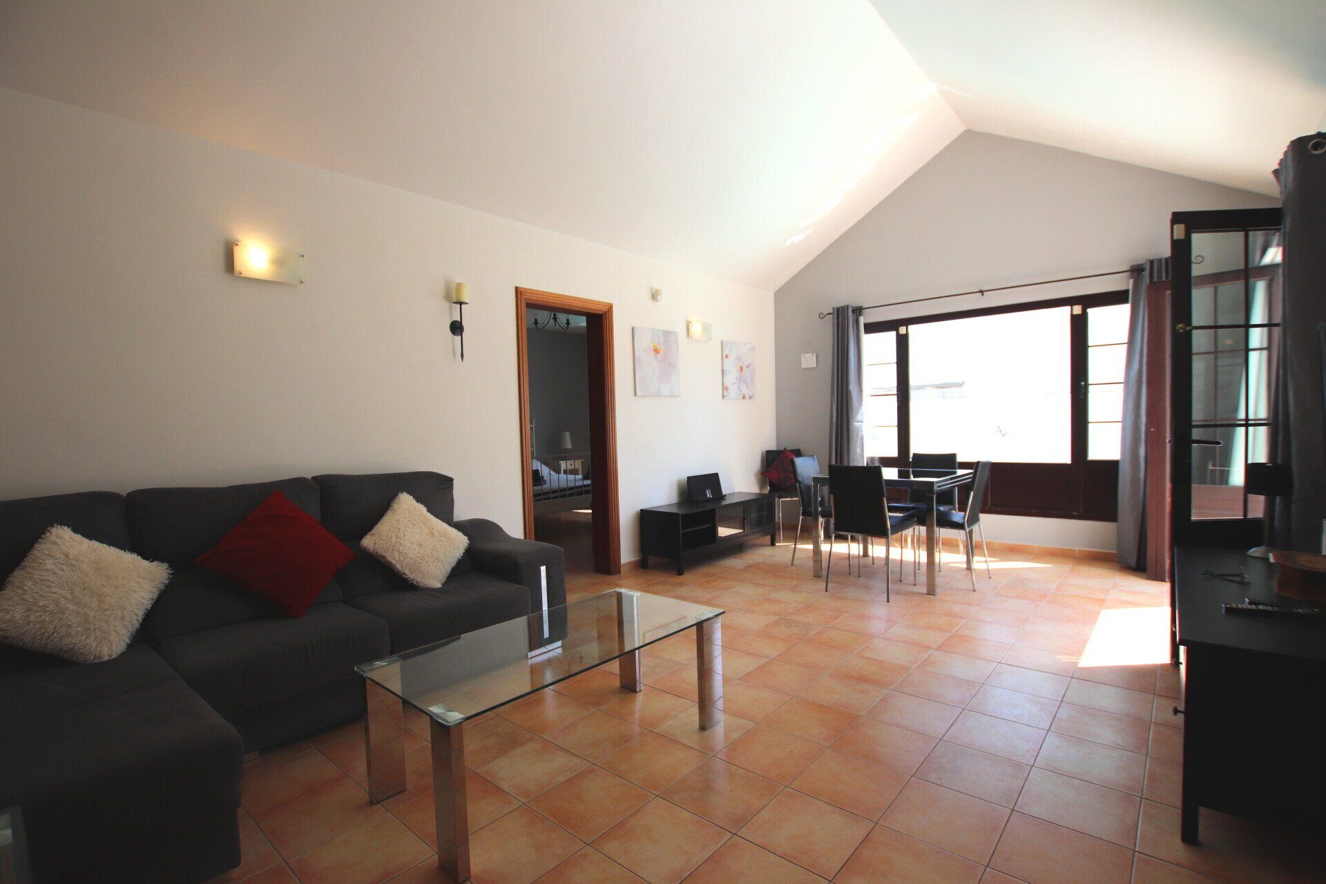 A living room with a couch , table and chairs