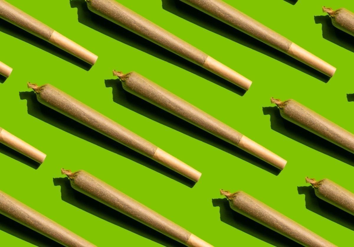 A group of cigarettes are sitting on top of a wooden tray.