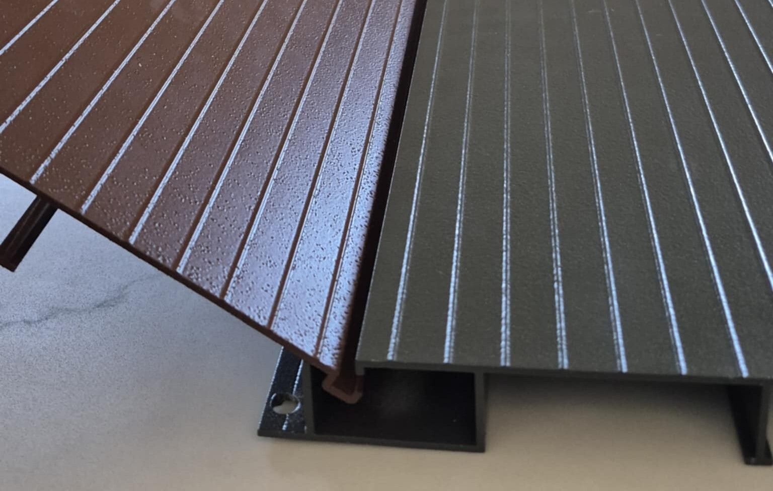 A close up of a wooden deck and a gray deck