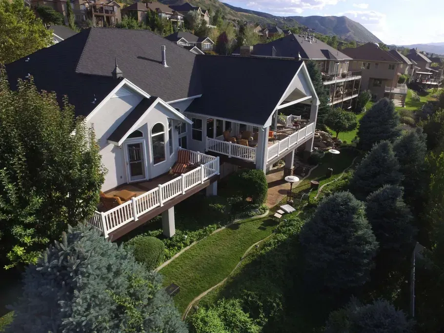 An aerial view of a house with a large deck