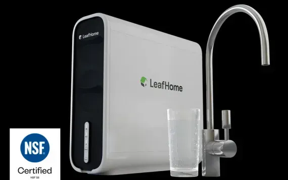 White water filter system with faucet, glass, and NSF certification logo.