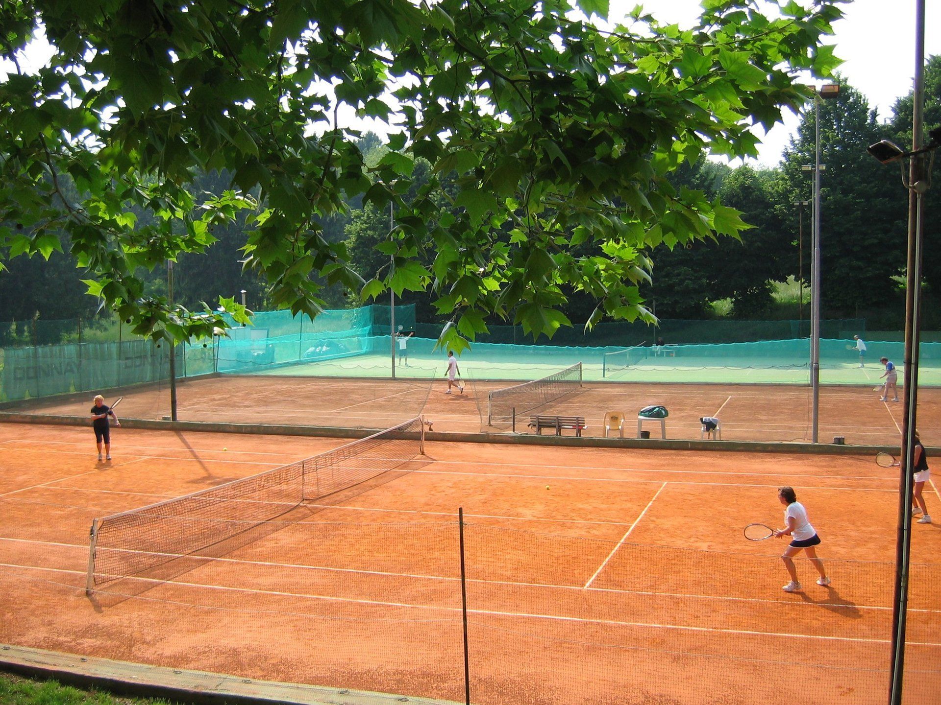 view from above of a tennis court with people playing