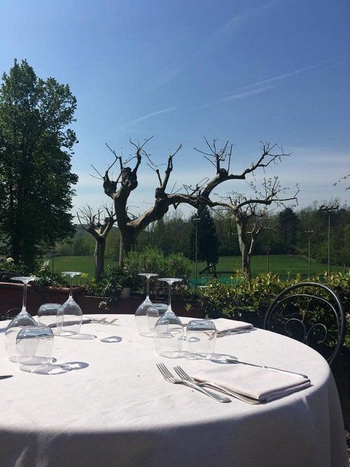 a round table set for dining with view of trees