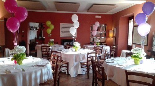 tables in a restaurant and coloured baloons