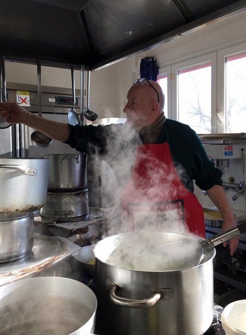 a steaming pot and a chef in a kitchen