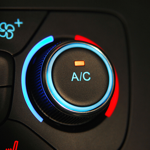 Car's A/C control knob, black with a blue illuminated border for cool and red for warm settings. The 