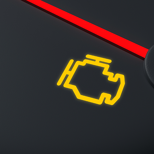 Yellow engine-shaped warning light illuminated on a black dashboard.