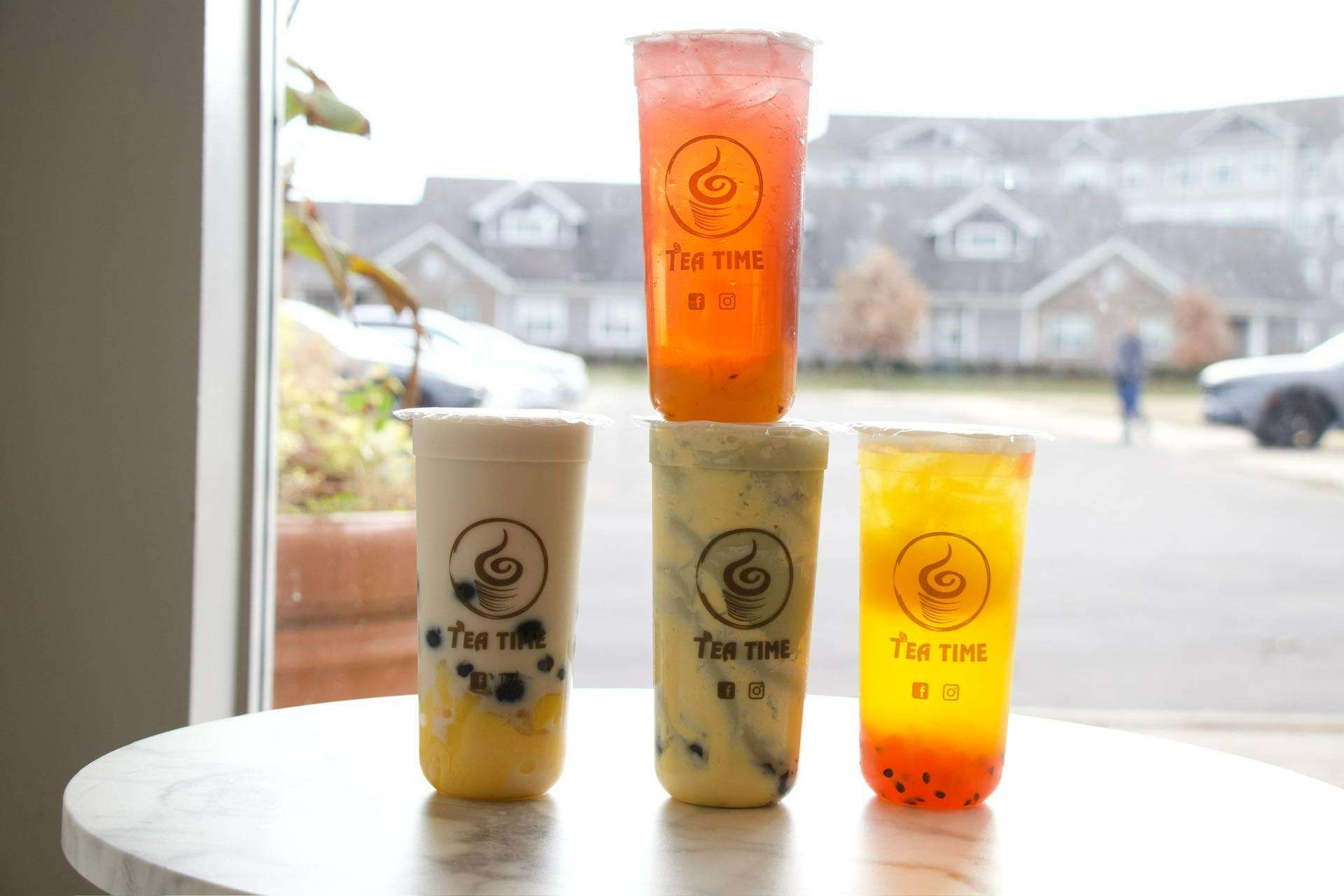 Four cups of tea are stacked on top of each other on a table.