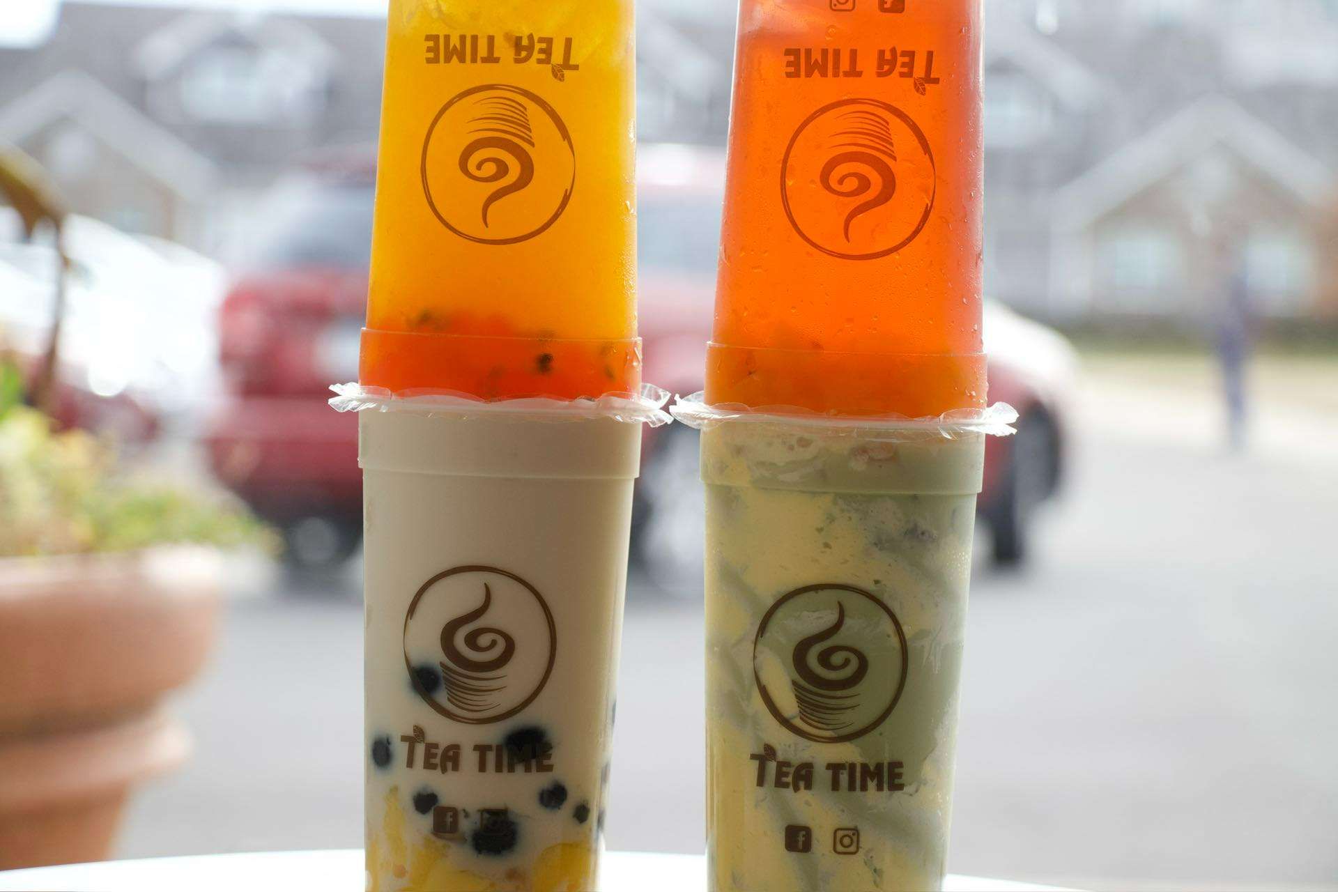 Two cups of tea are stacked on top of each other on a table.